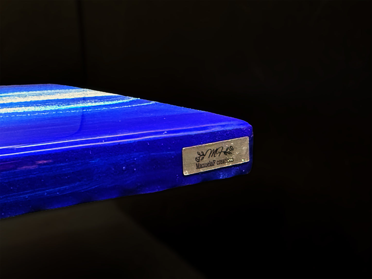 Artist badge on the edge of the art piece