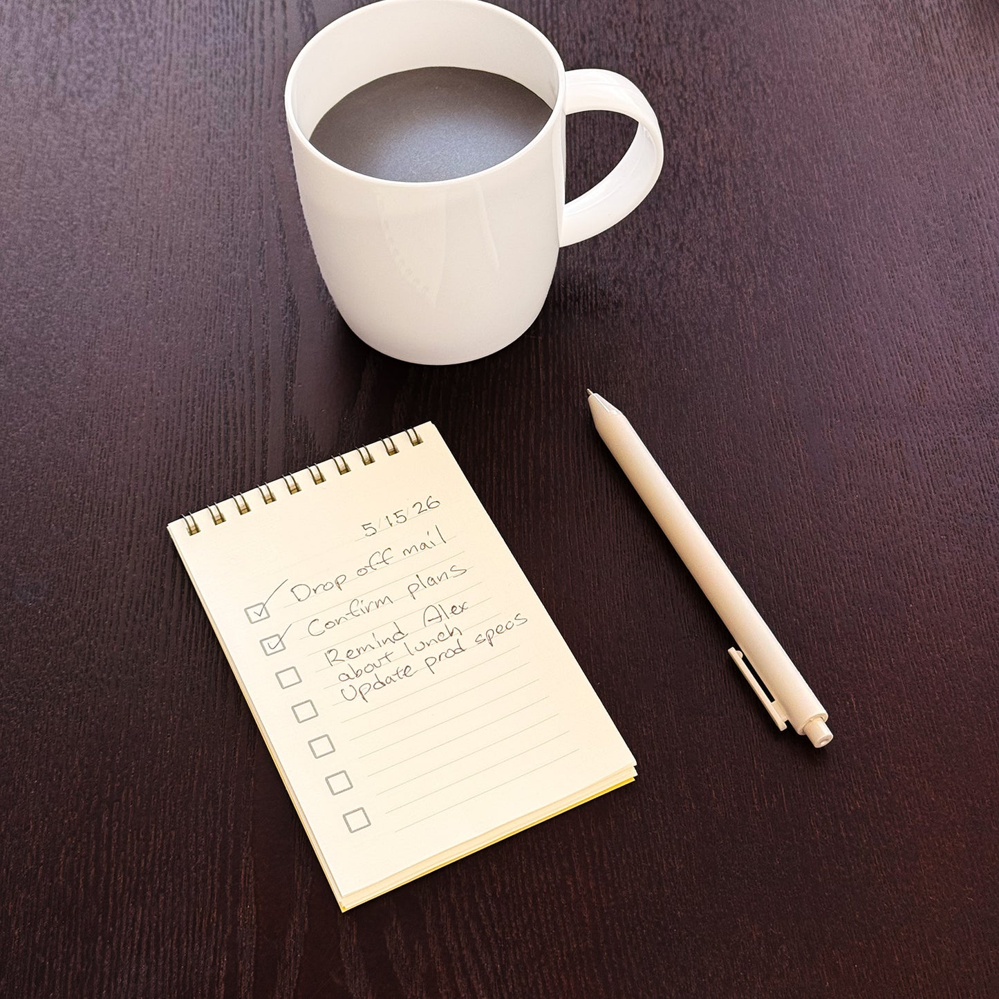 Pad with to-do page filled out and a coffee cup and pen