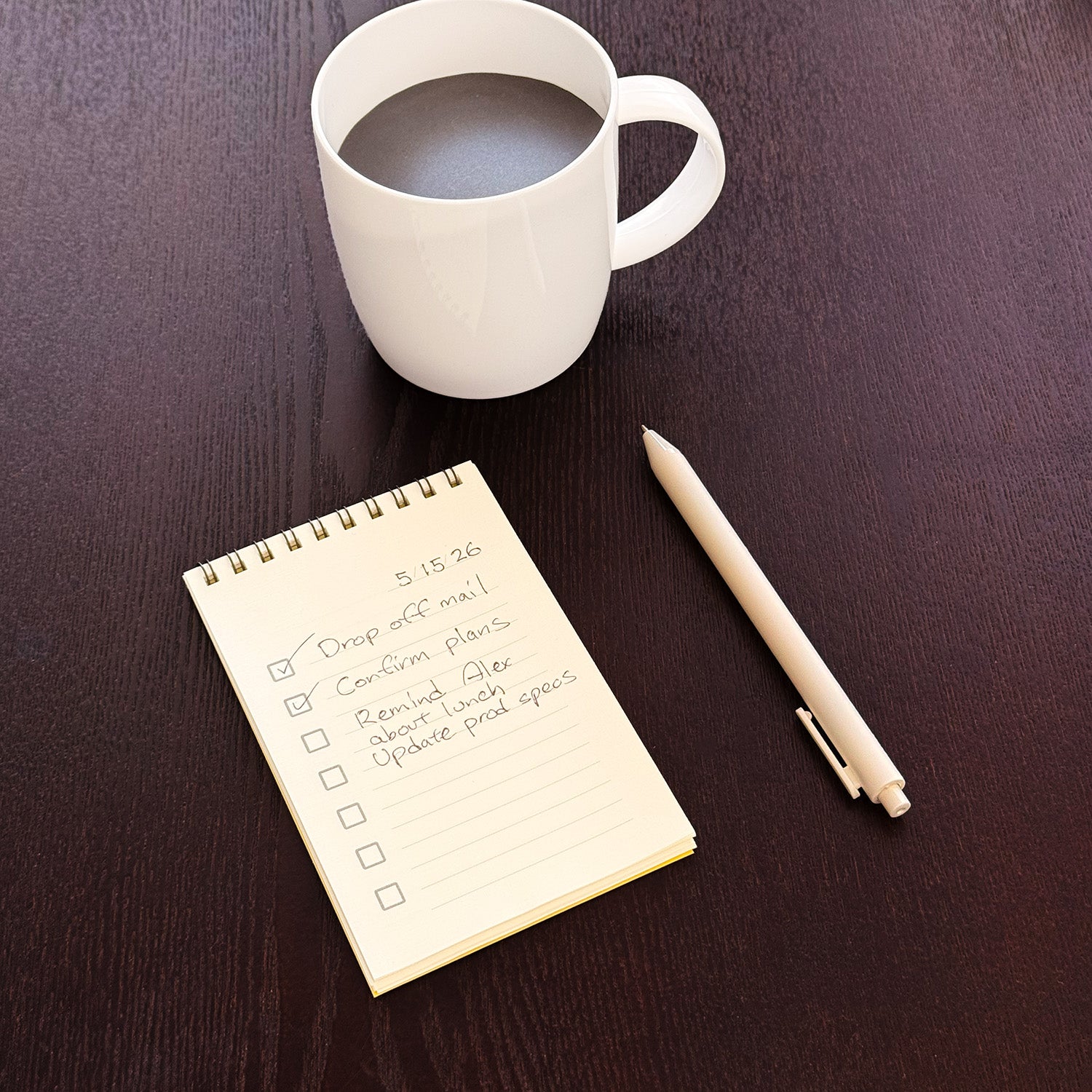 Pad with to-do page filled out and a coffee cup and pen