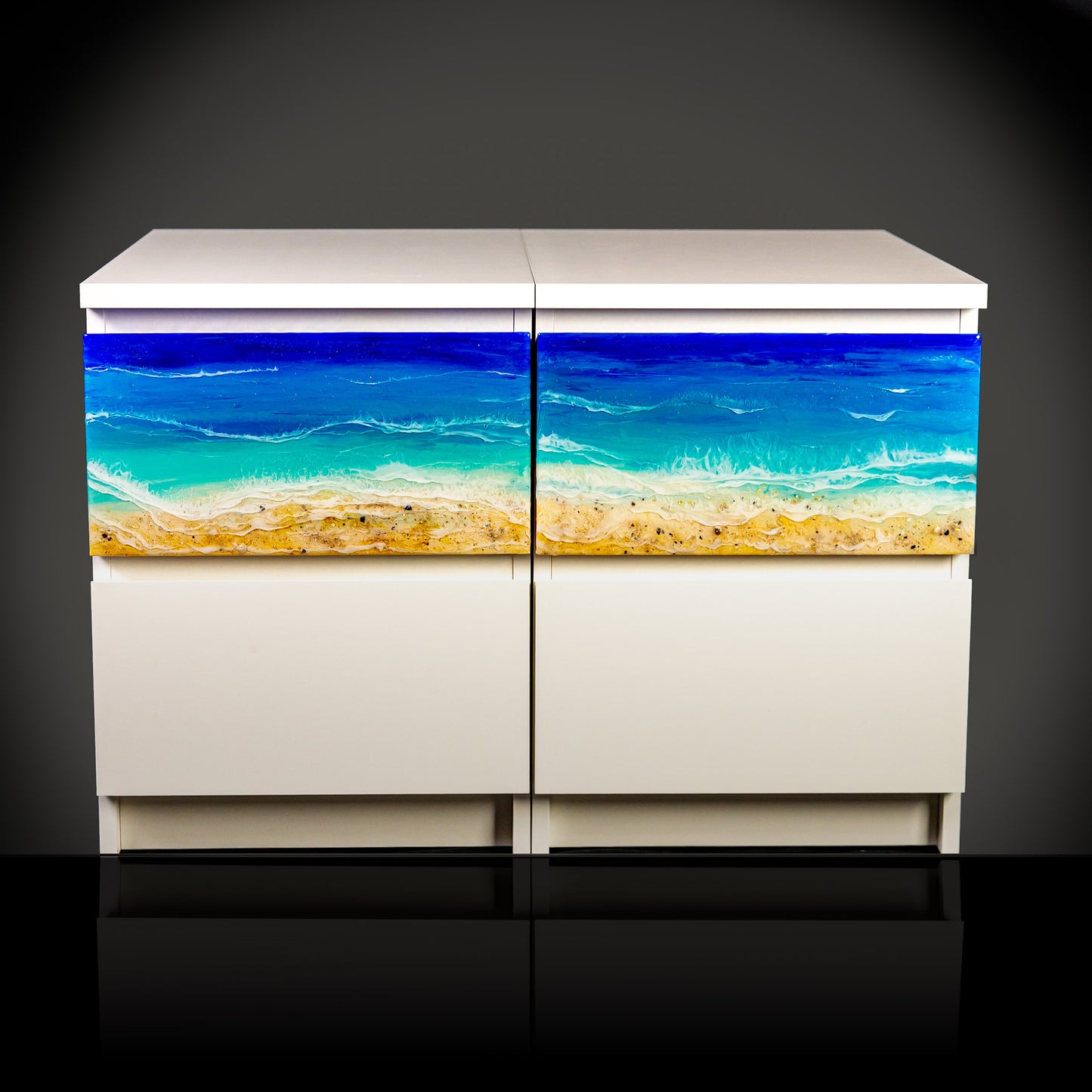 Ocean art pieces installed on white furniture