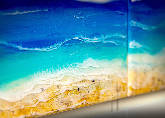 Close-up of ocean art pieces on white furniture