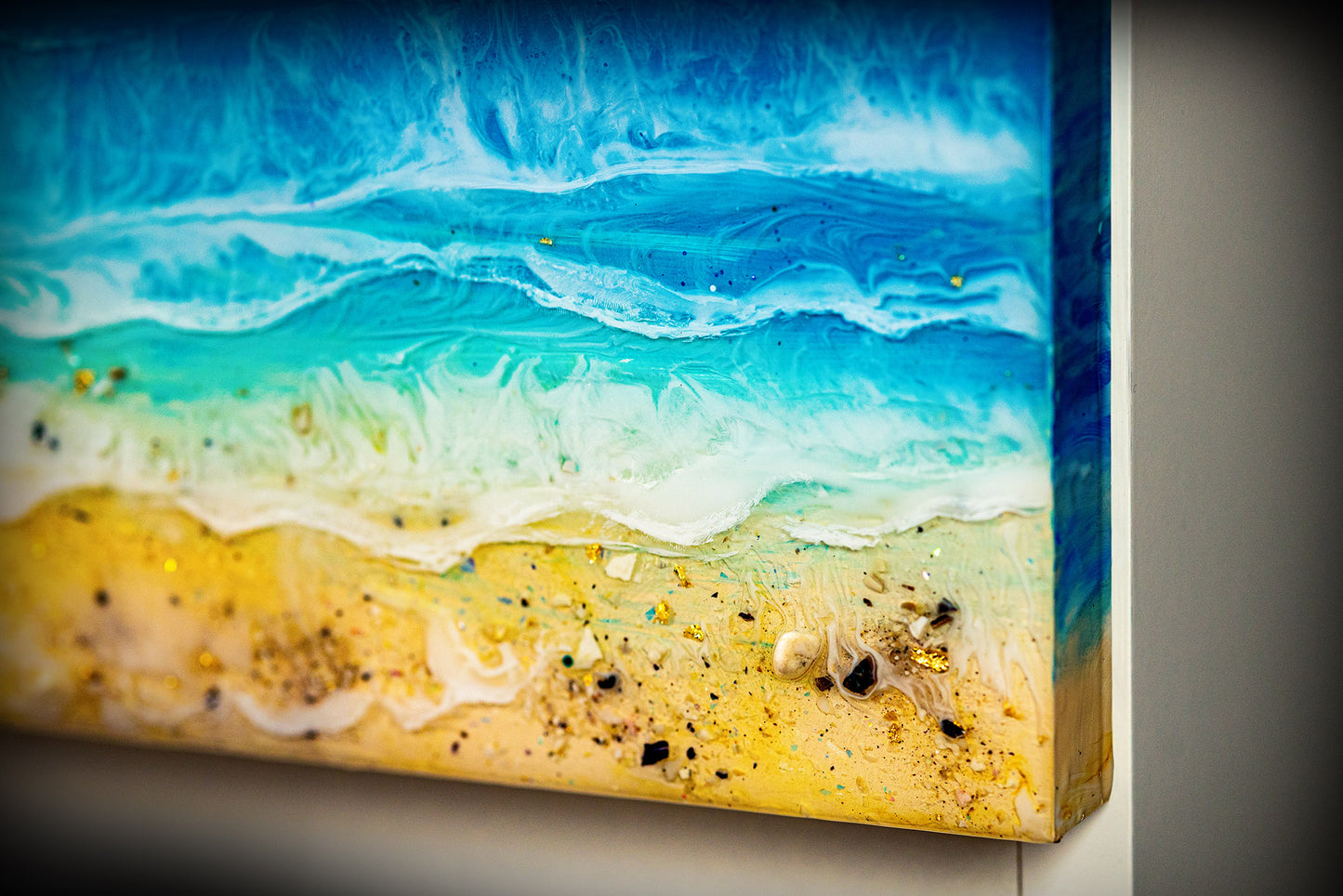 Ocean art installed on a white cabinet