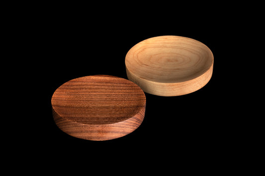 One dark and one light circular wood spoon rest
